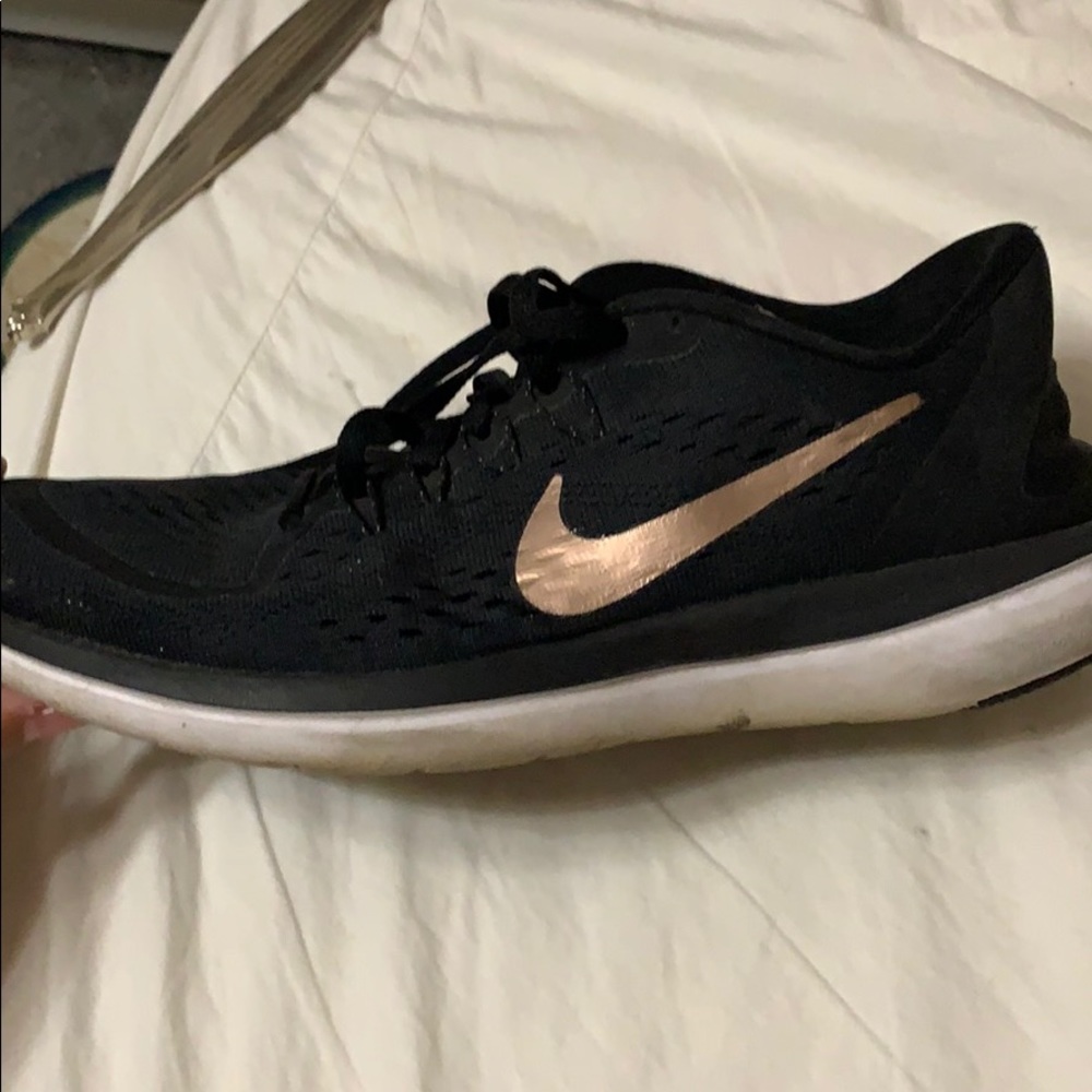 Woman’s gold and black sneakers